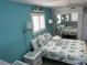 Cozy bedroom with tropical bedding, white wicker furniture, and beach themed decor at 800 Bayway Blvd # 14, Clearwater Beach, FL 33767