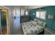 View from the bedroom showing the beach themed bedding and a glimpse of the swimming pool at 800 Bayway Blvd # 14, Clearwater Beach, FL 33767
