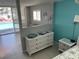 Bright bedroom with a coastal-themed dresser, decor, and access to the outdoor patio at 800 Bayway Blvd # 14, Clearwater Beach, FL 33767