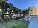 Community picnic area with lush landscaping, seating, and barbecue grills for residents at 800 Bayway Blvd # 14, Clearwater Beach, FL 33767