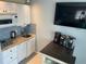 Efficient kitchenette setup with white cabinets, sink, microwave and a coffee station at 800 Bayway Blvd # 14, Clearwater Beach, FL 33767