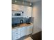 A practical kitchenette featuring white cabinets and modern appliances including microwave at 800 Bayway Blvd # 14, Clearwater Beach, FL 33767