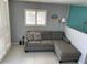Comfortable living room featuring a gray couch and neutral decor in a well-lit space at 800 Bayway Blvd # 14, Clearwater Beach, FL 33767