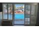 Patio doors open to views of a sparkling swimming pool in an inviting outdoor space at 800 Bayway Blvd # 14, Clearwater Beach, FL 33767