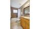 Bathroom with tiled bath and shower, window and wood vanity at 821 52Nd S Ave, St Petersburg, FL 33705
