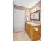 Bathroom with double sink vanity, tile floors, and framed mirror at 821 52Nd S Ave, St Petersburg, FL 33705