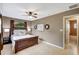 Bedroom with warm tones, a ceiling fan, and an adjacent bathroom with a tub and shower at 821 52Nd S Ave, St Petersburg, FL 33705