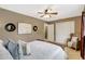 Relaxing bedroom featuring neutral walls, ceiling fan, artwork, closet, and comfortable seating at 821 52Nd S Ave, St Petersburg, FL 33705