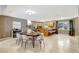 Open floor plan with dining area, tile floors, kitchen breakfast bar and large window at 821 52Nd S Ave, St Petersburg, FL 33705