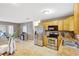 Bright kitchen with stainless steel appliances, wood cabinets and view into living room at 821 52Nd S Ave, St Petersburg, FL 33705