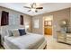 Bright bedroom featuring a view to the ensuite bath, tile floors, and a ceiling fan at 821 52Nd S Ave, St Petersburg, FL 33705