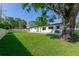 Spacious backyard with patio, lush grass, and mature tree, perfect for outdoor entertaining and relaxation at 8444 15Th N Way, St Petersburg, FL 33702
