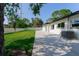 Large backyard featuring a paver patio and well-maintained lawn with lush grass and shade from mature trees at 8444 15Th N Way, St Petersburg, FL 33702