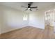 Bright bedroom features light wood floors, ceiling fan, and access to additional rooms at 8444 15Th N Way, St Petersburg, FL 33702