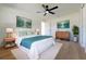 Bright bedroom featuring wood floors, a ceiling fan, stylish decor, and a comfortable king-size bed at 8444 15Th N Way, St Petersburg, FL 33702