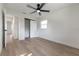 Bright bedroom features light wood floors, ceiling fan, and a closet with sliding doors at 8444 15Th N Way, St Petersburg, FL 33702