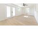 Bright bedroom features light wood floors, ceiling fan, French doors and sliding frosted doors at 8444 15Th N Way, St Petersburg, FL 33702