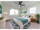 Bright bedroom with plenty of natural light, a ceiling fan, wood floors, and stylish furnishings at 8444 15Th N Way, St Petersburg, FL 33702