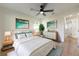 Cozy bedroom featuring wood floors, neutral decor, and a large bed with soft bedding and new ceiling fan at 8444 15Th N Way, St Petersburg, FL 33702