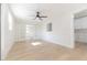 Bright bedroom features light wood floors, a ceiling fan, and frosted sliding doors at 8444 15Th N Way, St Petersburg, FL 33702
