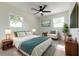 Cozy bedroom with two windows, a ceiling fan, a large bed, and stylish, comfortable furniture at 8444 15Th N Way, St Petersburg, FL 33702