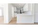 Bright, remodeled kitchen with white cabinets, a breakfast bar, and stainless steel appliances at 8444 15Th N Way, St Petersburg, FL 33702