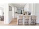Sleek kitchen with a breakfast bar, modern bar stools, light countertops and ample cabinet space at 8444 15Th N Way, St Petersburg, FL 33702