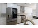 Well-equipped kitchen with a stainless steel refrigerator, an oven range, and pristine white cabinetry at 8444 15Th N Way, St Petersburg, FL 33702