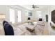 Sun-filled living room with access to a patio, complete with elegant furniture and a stylish ceiling fan at 8444 15Th N Way, St Petersburg, FL 33702