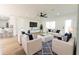 Bright living room featuring white furnishings, a ceiling fan, wood floors, and lots of natural light at 8444 15Th N Way, St Petersburg, FL 33702