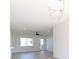 Bright living room features a modern chandelier, ceiling fan, and neutral paint at 8444 15Th N Way, St Petersburg, FL 33702