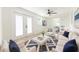Inviting living room featuring natural light, wood flooring, a ceiling fan, and bright white furnishings at 8444 15Th N Way, St Petersburg, FL 33702