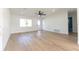 Bright living room with light hardwood floors and a ceiling fan at 8444 15Th N Way, St Petersburg, FL 33702