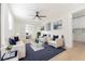 Spacious living room with an open floor plan, neutral decor, wood floors, and white couches with blue pillows at 8444 15Th N Way, St Petersburg, FL 33702