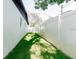 Side yard featuring lush green lawn and white fence at 8444 15Th N Way, St Petersburg, FL 33702