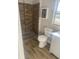 Updated bathroom featuring a tiled shower, modern vanity, and natural light at 8502 Grapefruit Ave, Tampa, FL 33619