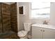 Modern bathroom features updated vanity, a mirror, and a beautifully tiled shower at 8502 Grapefruit Ave, Tampa, FL 33619