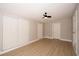 Bright bedroom featuring wood floors, ceiling fan, closet and fresh paint at 8502 Grapefruit Ave, Tampa, FL 33619