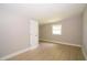Bright bedroom features a window, neutral paint, and new vinyl plank flooring at 8502 Grapefruit Ave, Tampa, FL 33619