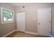 Comfortable bedroom with closet, window and neutral walls at 8502 Grapefruit Ave, Tampa, FL 33619