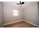 Bedroom with wood floors, ceiling fan and window at 8502 Grapefruit Ave, Tampa, FL 33619