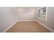 A bright, empty bedroom featuring wood-look floors and a large window for natural light at 8502 Grapefruit Ave, Tampa, FL 33619