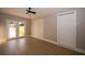 Bright bedroom features vinyl floor, ceiling fan, and a glass door to the backyard at 8502 Grapefruit Ave, Tampa, FL 33619