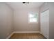 Cozy bedroom featuring wood floors, a ceiling fan, closet and a bright window at 8502 Grapefruit Ave, Tampa, FL 33619