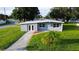 Charming, single-story home boasts a freshly painted exterior, well-manicured lawn, and inviting curb appeal at 8502 Grapefruit Ave, Tampa, FL 33619