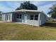 Charming gray home with white trim, well-kept lawn, and inviting front entrance at 8502 Grapefruit Ave, Tampa, FL 33619