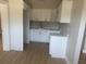 Bright kitchen features white cabinetry, stone countertops, and stainless steel sink at 8502 Grapefruit Ave, Tampa, FL 33619
