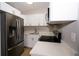 The newly updated kitchen boasts stainless steel appliances, white cabinets, and elegant countertops at 8502 Grapefruit Ave, Tampa, FL 33619