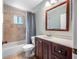 Bathroom with vanity, sink, toilet and tub with shower at 8514 Manassas Rd, Tampa, FL 33635