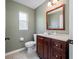 Nicely decorated bathroom features a wooden vanity, neutral walls, and plenty of natural light at 8514 Manassas Rd, Tampa, FL 33635